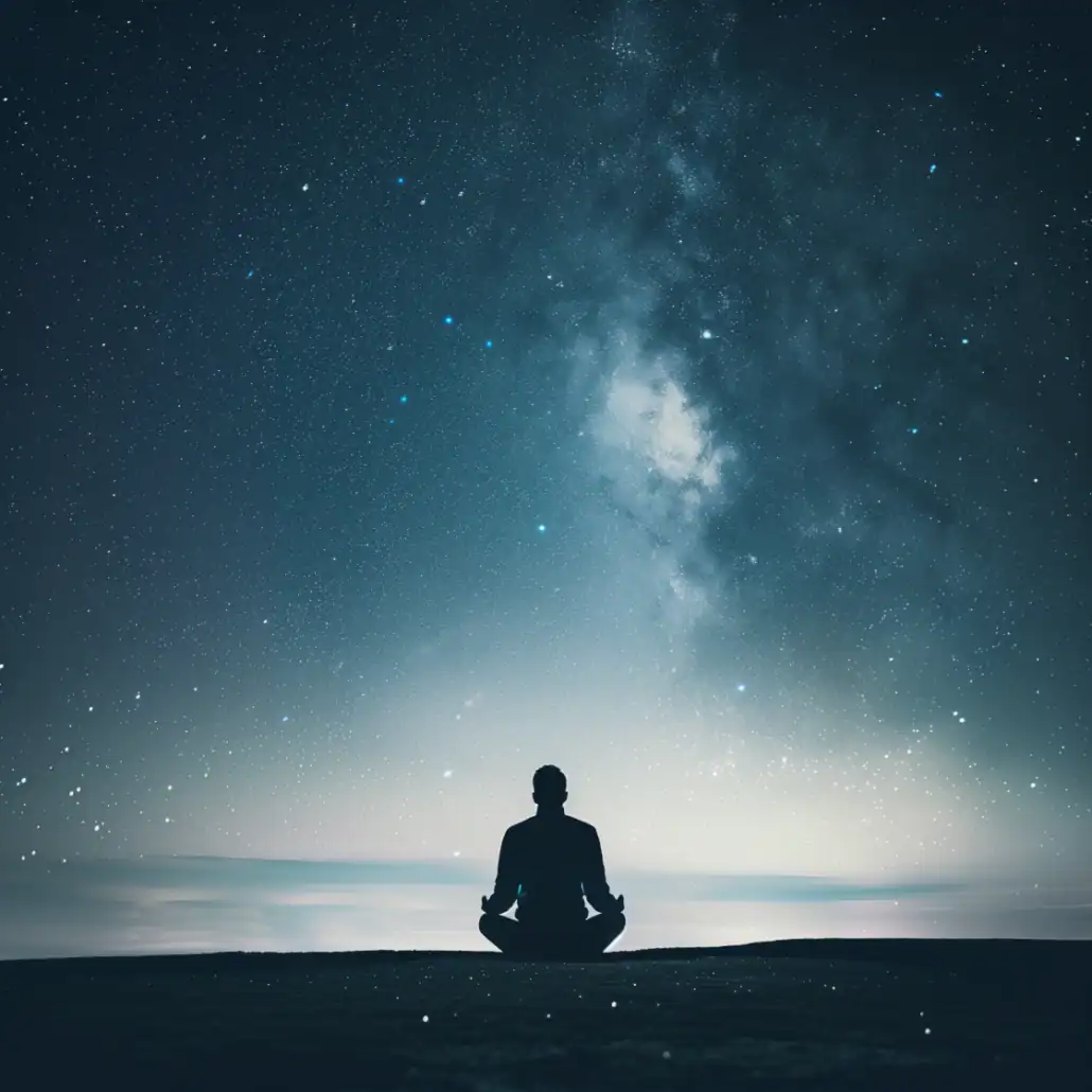 Person meditating under a calm starry sky, representing inner awareness and expanded consciousness