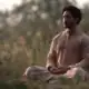 Indian male meditating with love in natural setting