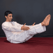 Yoga Master Anmol doing boat pose angled view