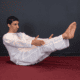 Yoga Master Anmol doing boat pose angled view