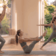 Beginner performing a 10 minute full body yoga workout at home with chair pose, warrior II and boat pose