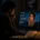 Man sitting alone at night forming an emotional connection with a beautiful AI companion displayed on his laptop screen.